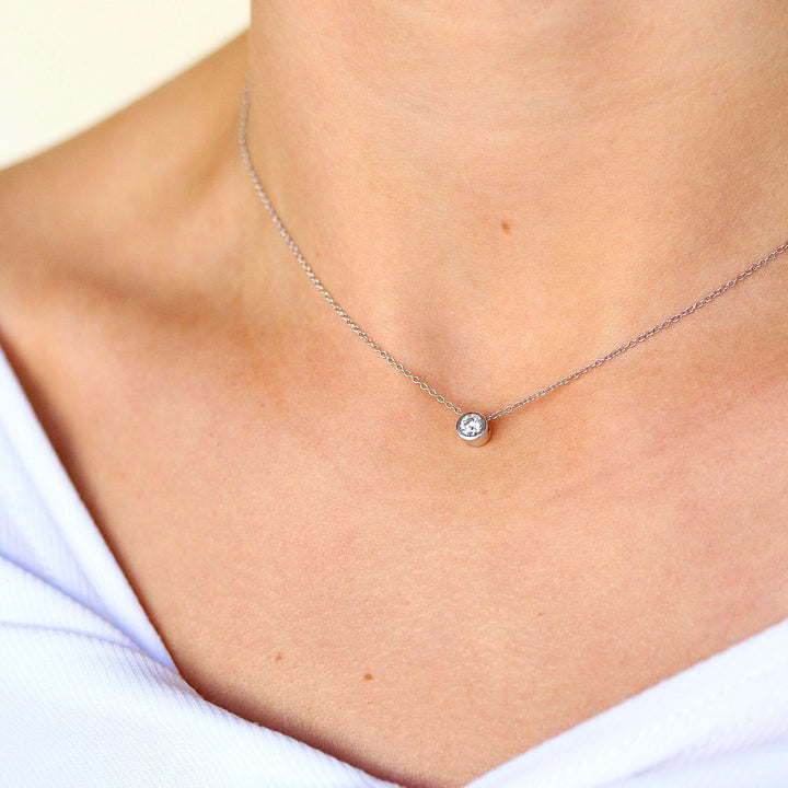 The 1/4ct Diamond Bezel Necklace in White Gold modeled on a neck