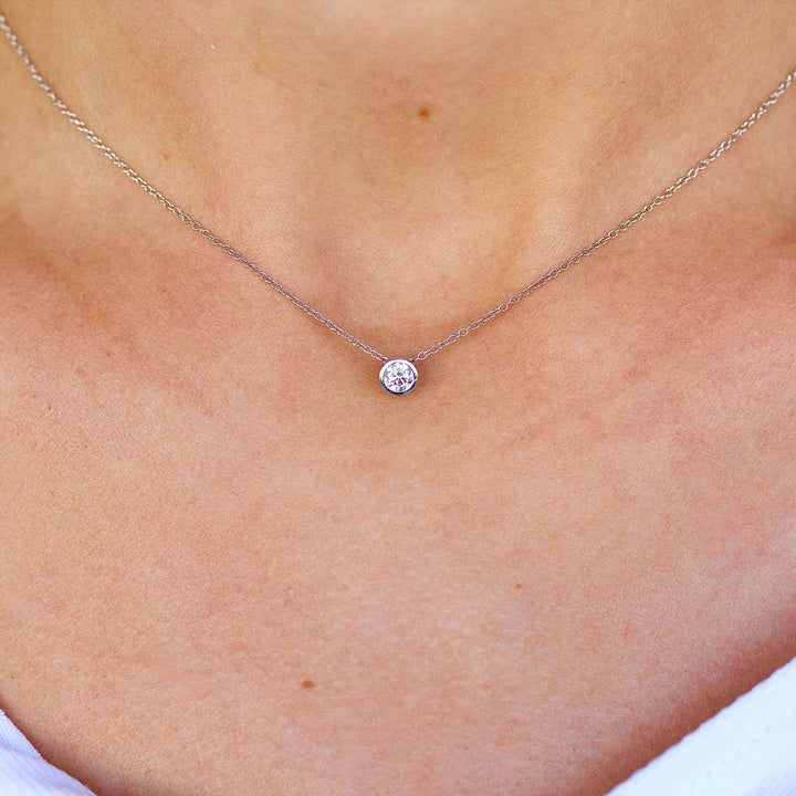 The 1/4ct Diamond Bezel Necklace in White Gold modeled on a neck