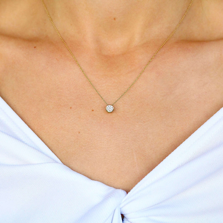 The 1/2ct Diamond Bezel Necklace in yellow gold modeled on a neck