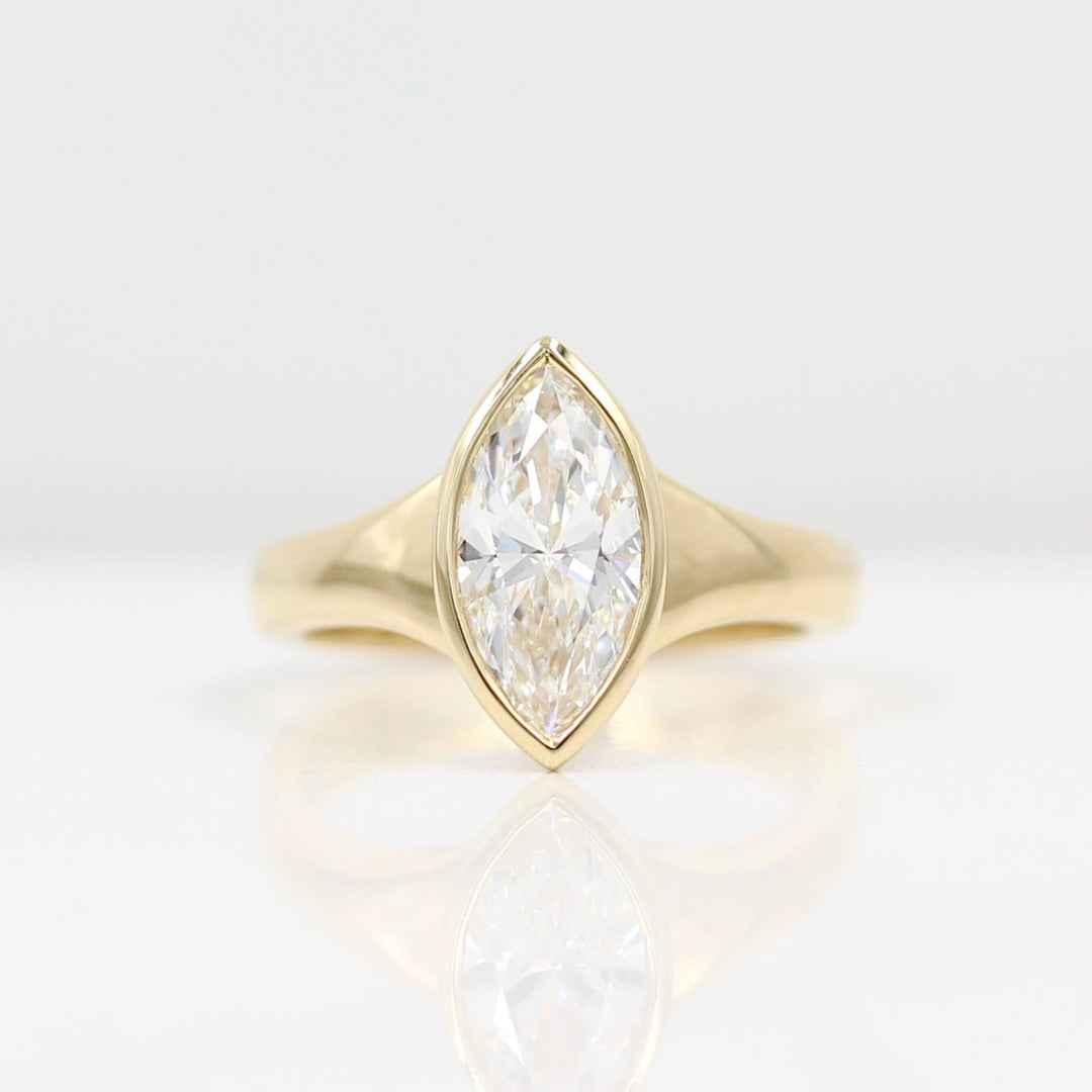 The Billie Ring (Marquise) in yellow gold against a white background