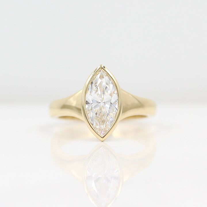 The Billie Ring (Marquise) in yellow gold against a white background
