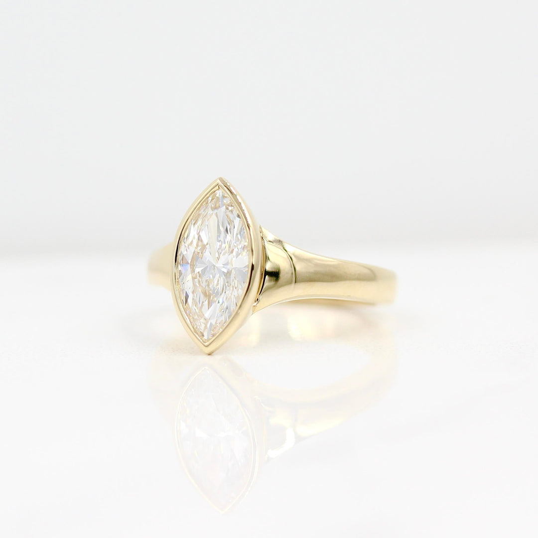 The Billie Ring (Marquise) in yellow gold against a white background