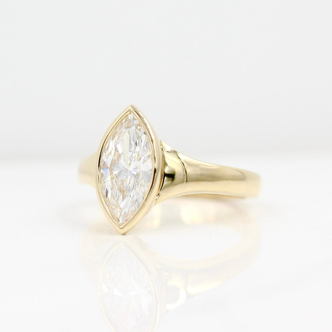 The Billie Ring (Marquise) in yellow gold against a white background