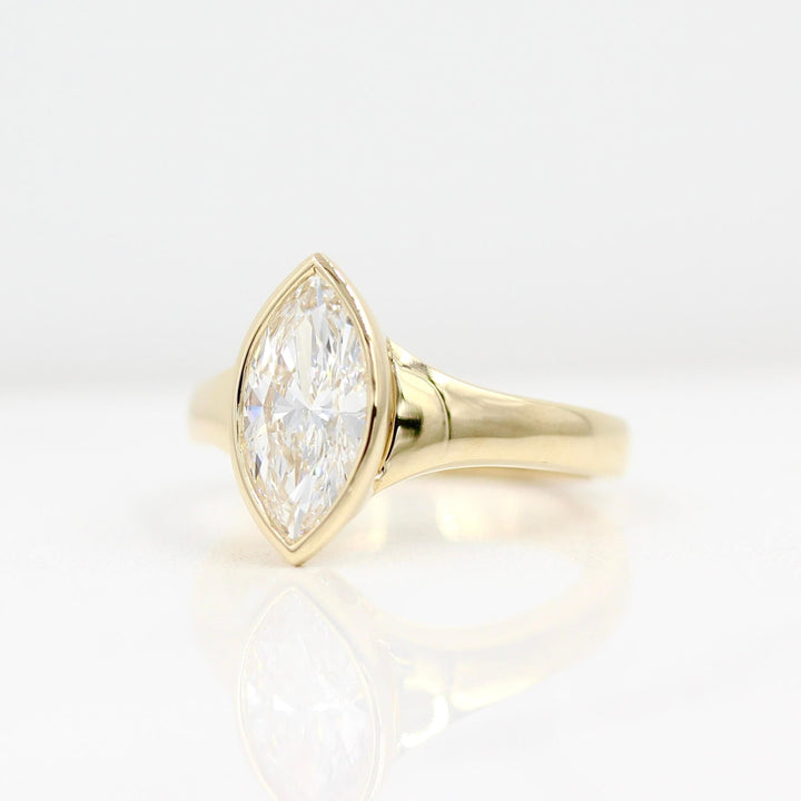 The Billie Ring (Marquise) in yellow gold against a white background