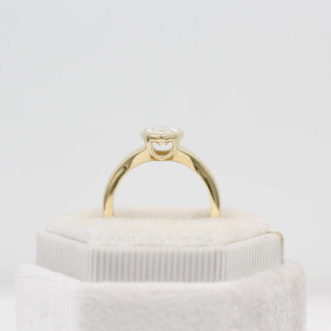 The Billie Ring (Marquise) in yellow gold in a white velvet ring box