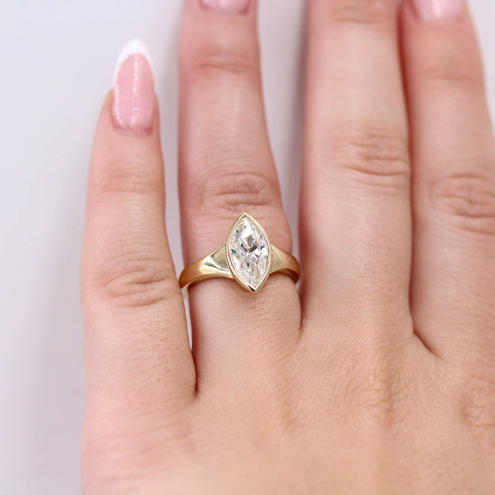 The Billie Ring (Marquise) in yellow gold modeled on a hand