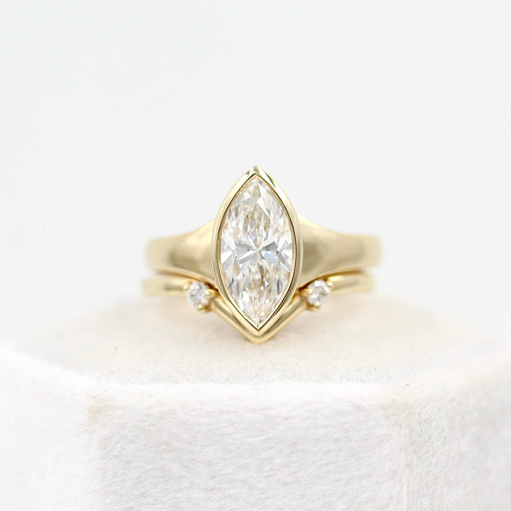 The Billie Ring (Marquise) in yellow gold stacked with the Double Diamond V Band in yellow gold on a white velvet ring box