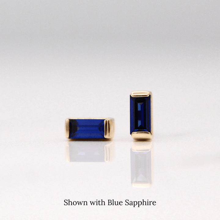 The September Baguette Birthstone Earrings with Blue Sapphire in Yellow Gold against a white background