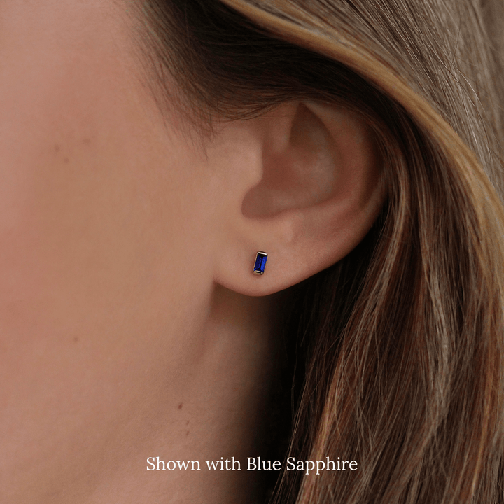 The September Baguette Birthstone Earrings with Blue Sapphire in Yellow Gold modeled