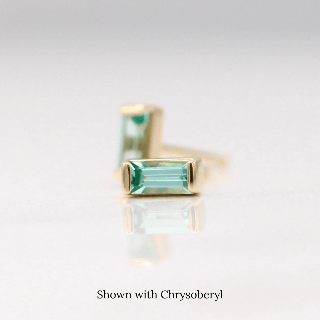 The March Baguette Birthstone Earrings with Chrysoberyl in Yellow Gold against a white background