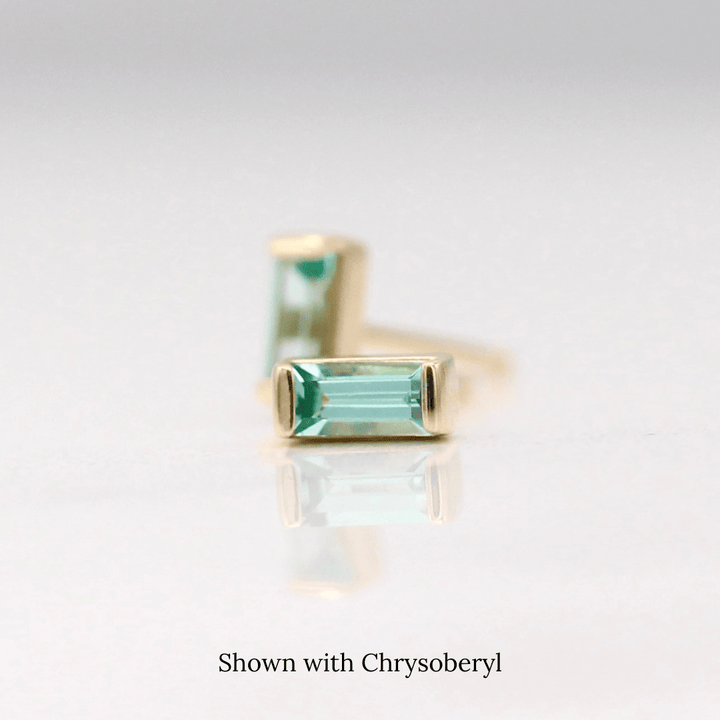 The March Baguette Birthstone Earrings with Chrysoberyl in Yellow Gold against a white background