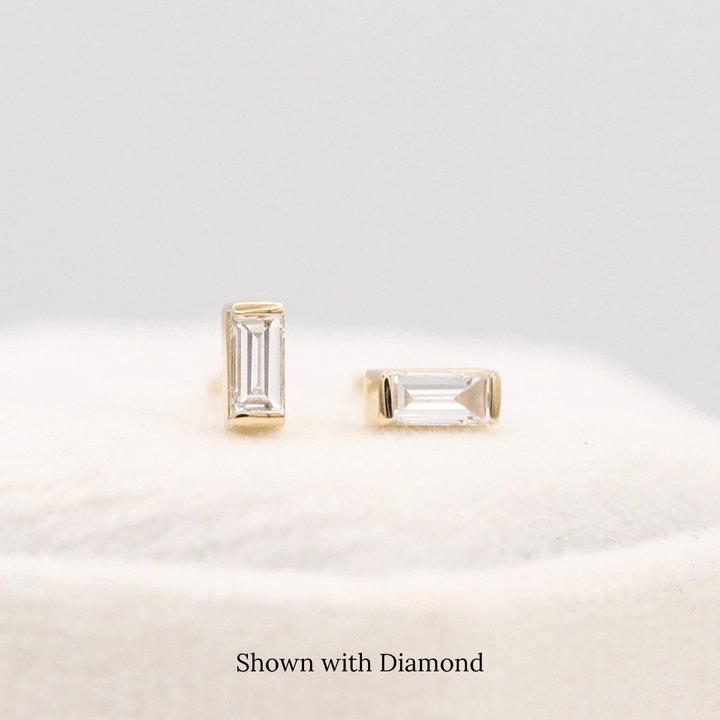 The April Baguette Birthstone Earrings with Lab-Grown Diamond in Yellow Gold atop of a white velvet ring box
