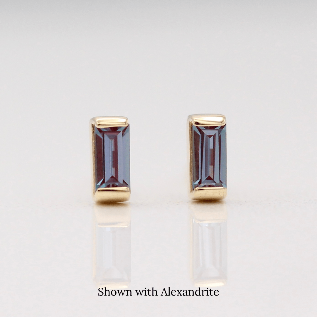 The June Baguette Birthstone Earrings with Alexandrite in Yellow Gold against a white background