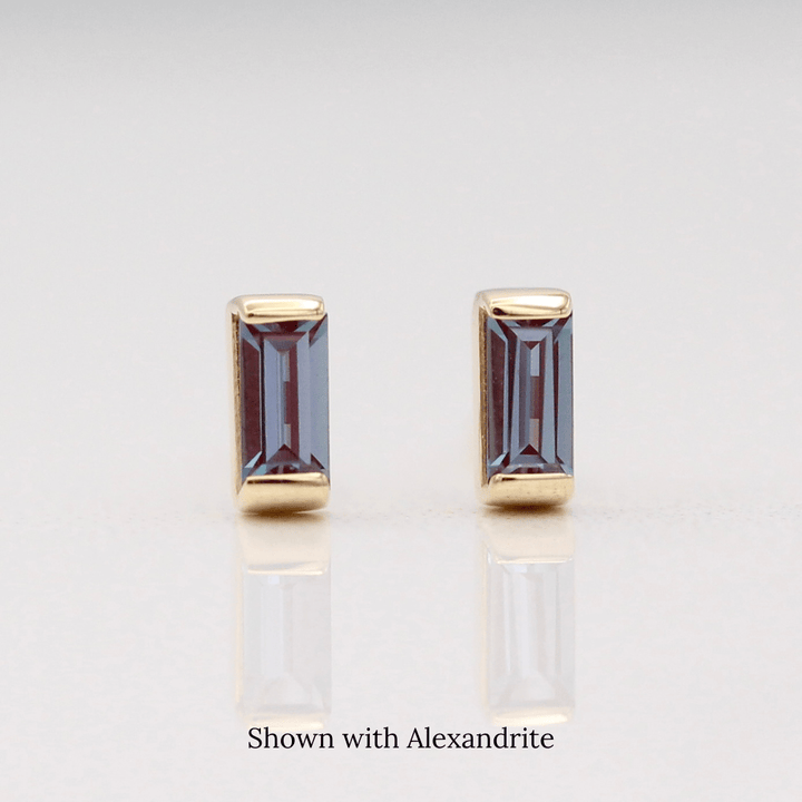 The June Baguette Birthstone Earrings with Alexandrite in Yellow Gold against a white background