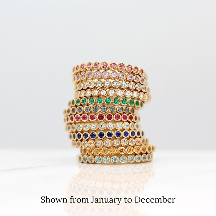 The stack of Florence Birthstone Bands in Yellow Gold from January to December