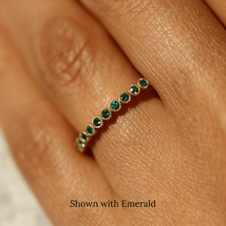 The May Florence Birthstone Band with Emerald in Yellow Gold modeled on a hand