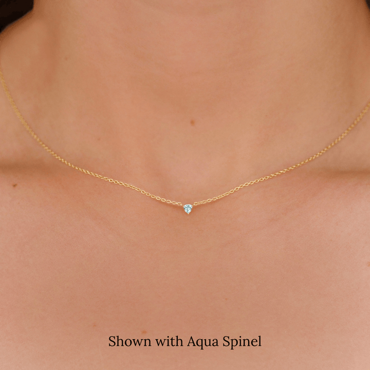 The March Tiny Trillion Birthstone Necklace with Aqua Spinel in Yellow Gold modeled
