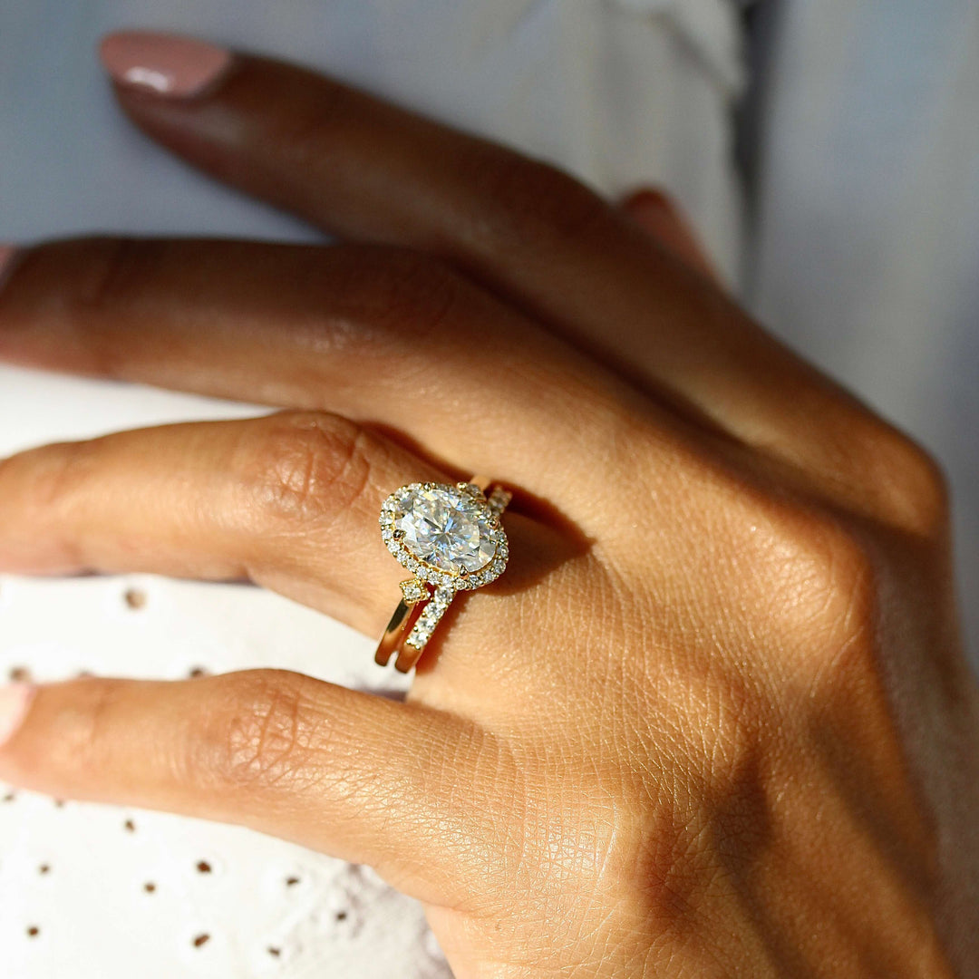 The Casey Ring (Oval) in Yellow Gold stacked with the Elizabeth wedding band in yellow gold modeled on a hand