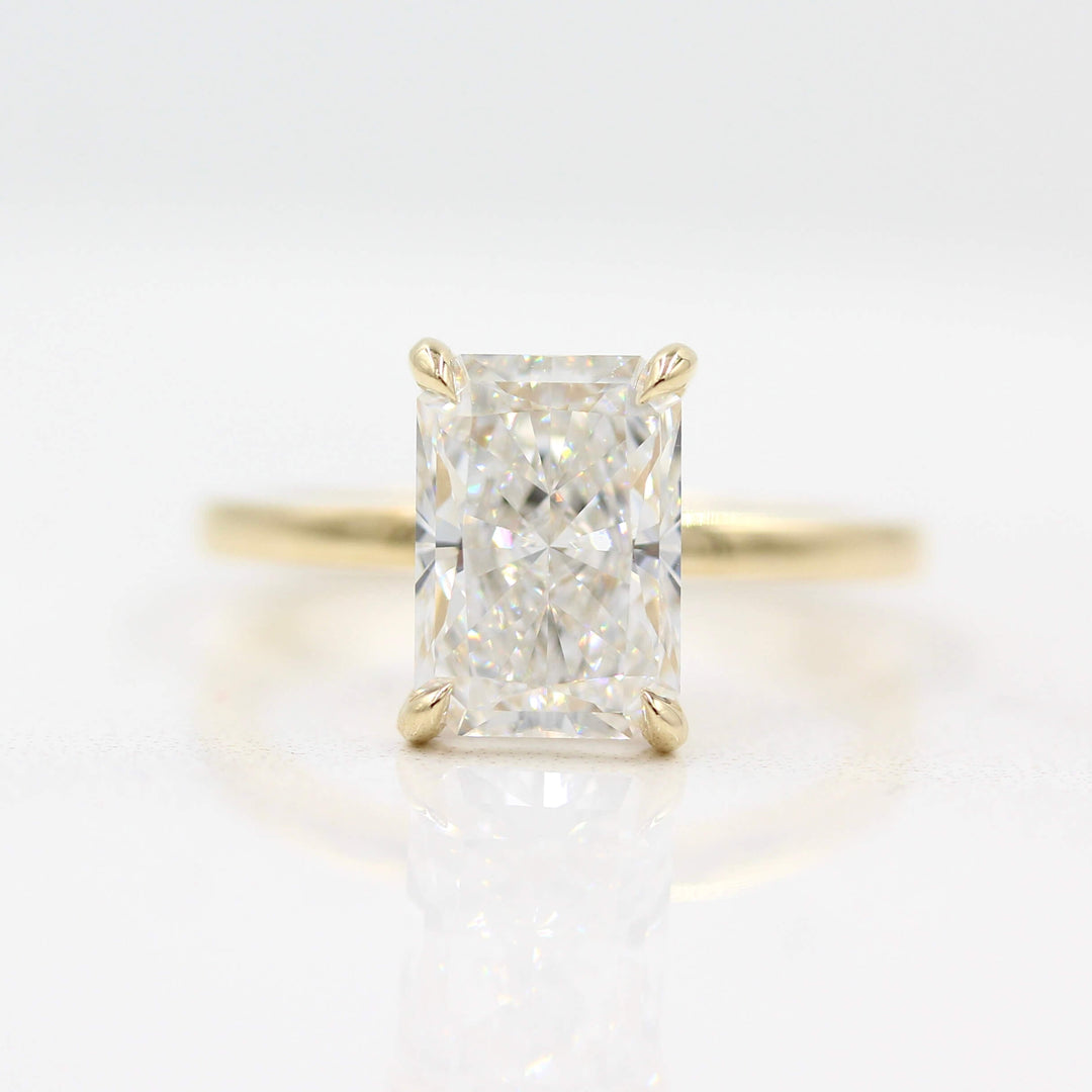 The Celeste Ring (Radiant) in Yellow Gold against a white background