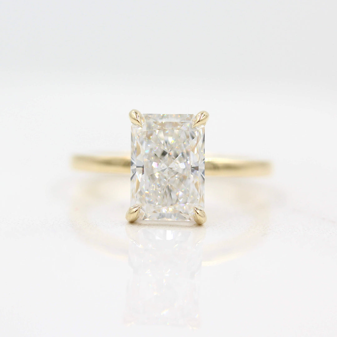 The Celeste Ring (Radiant) in Yellow Gold against a white background