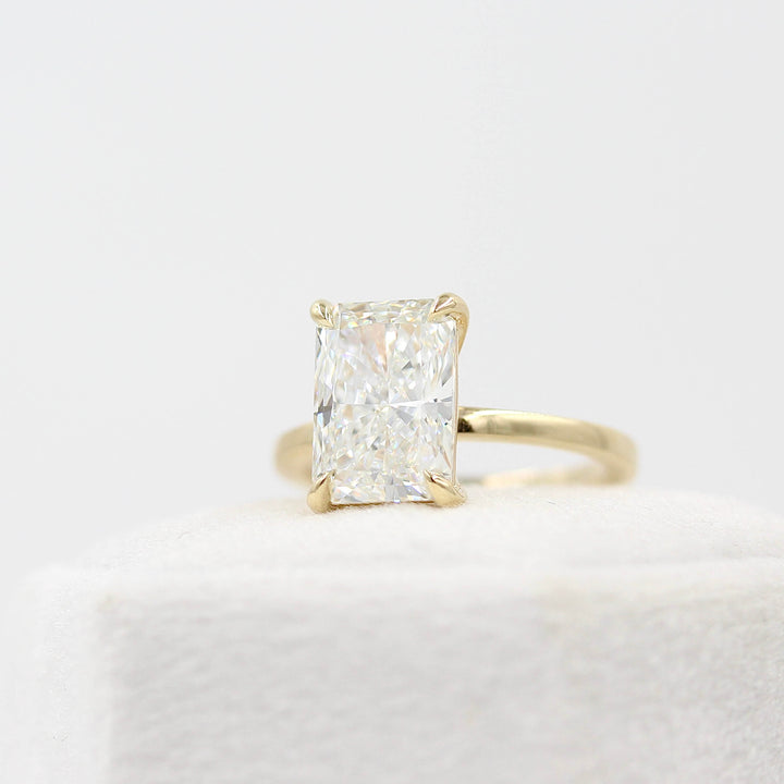 The Celeste Ring (Radiant) in Yellow Gold with 3.75ct Lab-Grown Diamond atop a white velvet ring box