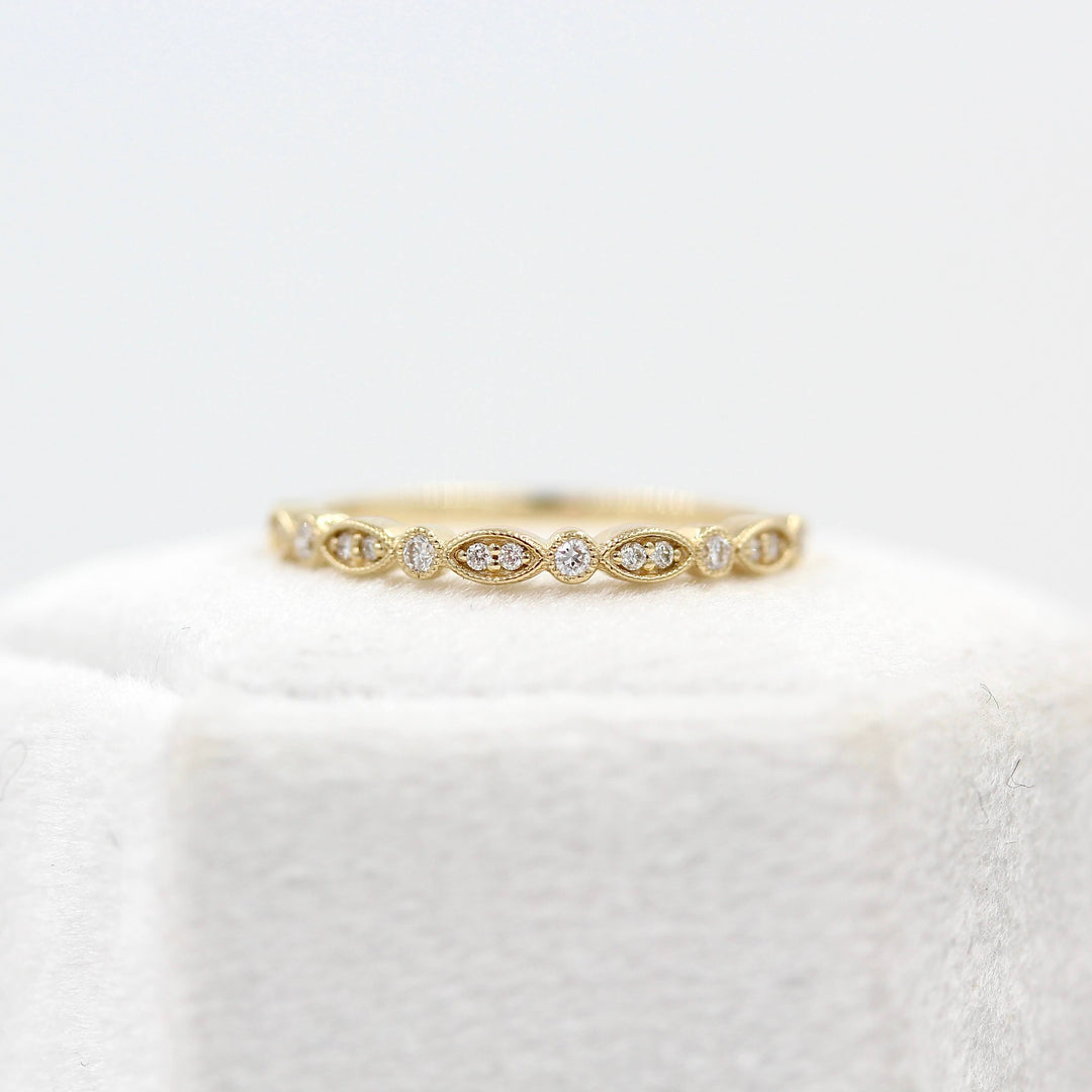 The Charlotte Wedding Band in Yellow Gold atop a ring box