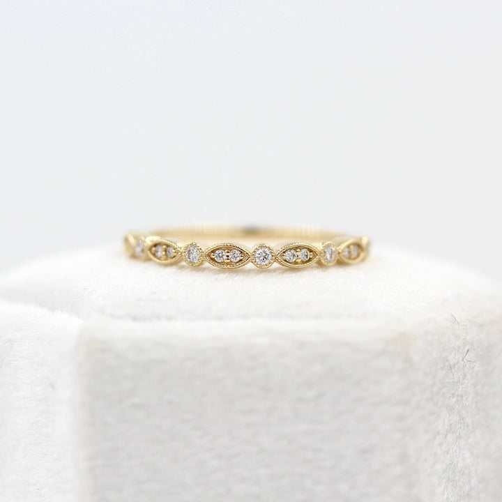 The Charlotte Wedding Band in Yellow Gold atop a ring box