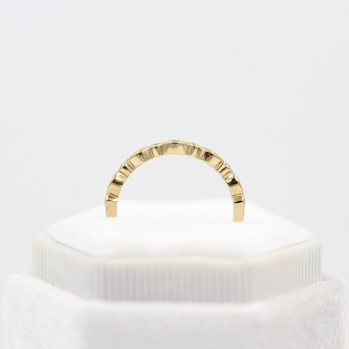 The Charlotte Wedding Band in Yellow Gold in a ring box's profile