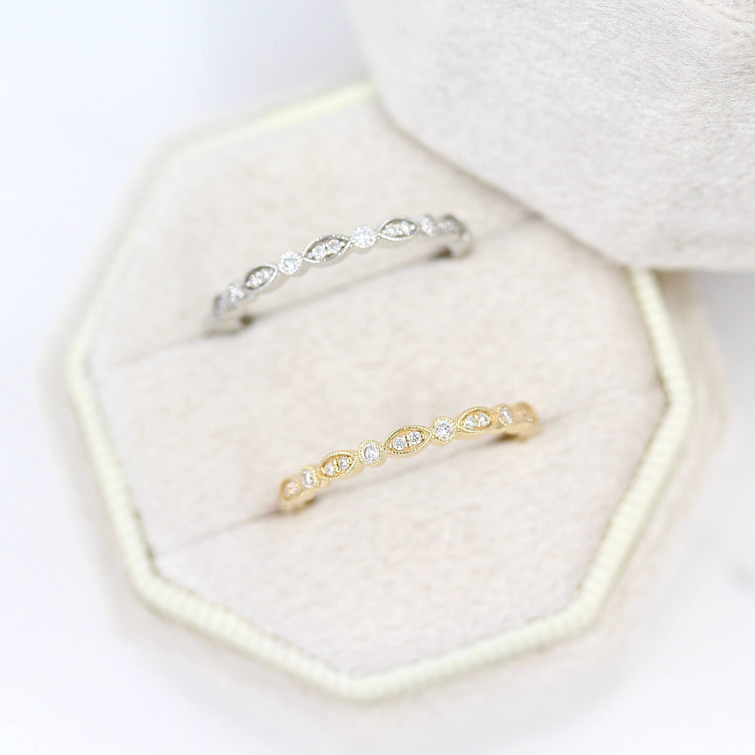 The Charlotte Wedding Band in Yellow Gold and The Charlotte Wedding Band in White Gold in a ring box