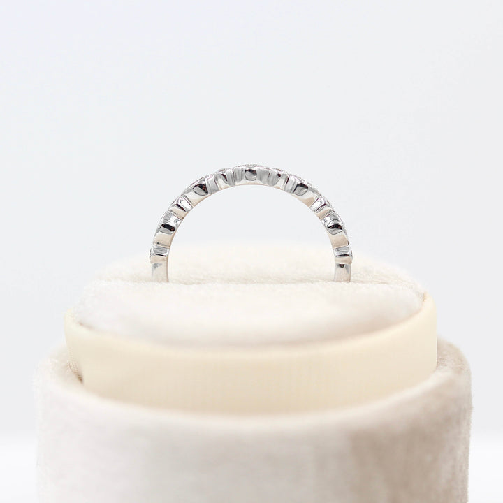 The Charlotte Wedding Band in White Gold in a ring box's profile