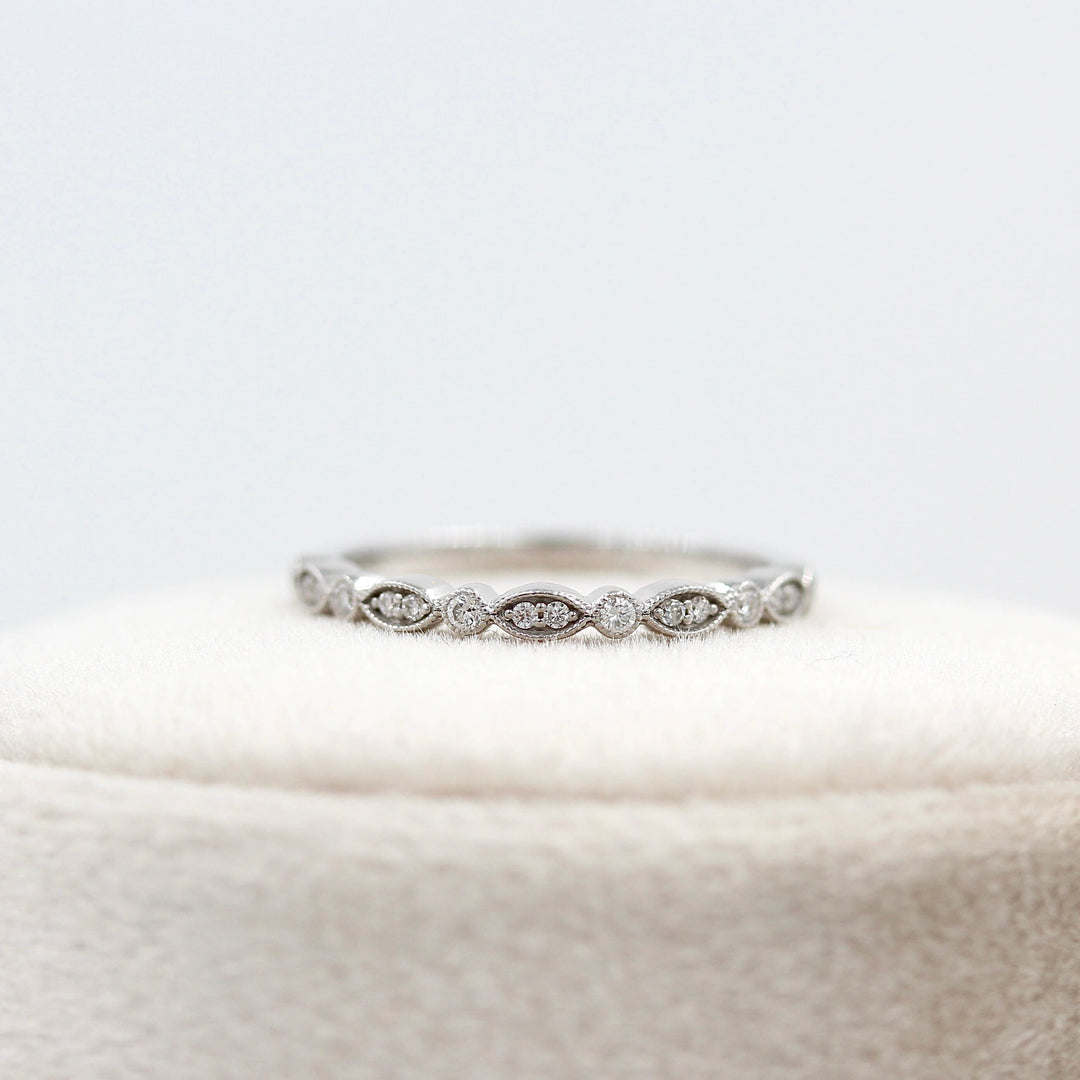 The Charlotte Wedding Band in White Gold atop a ring box