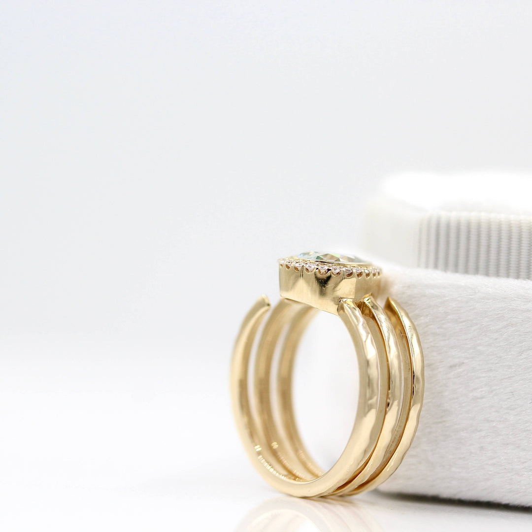The Chelsea ring in yellow gold leaning against a white velvet ring box