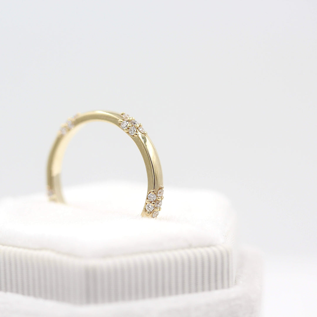 The Chloe Wedding Band in yellow gold in a white velvet ring box