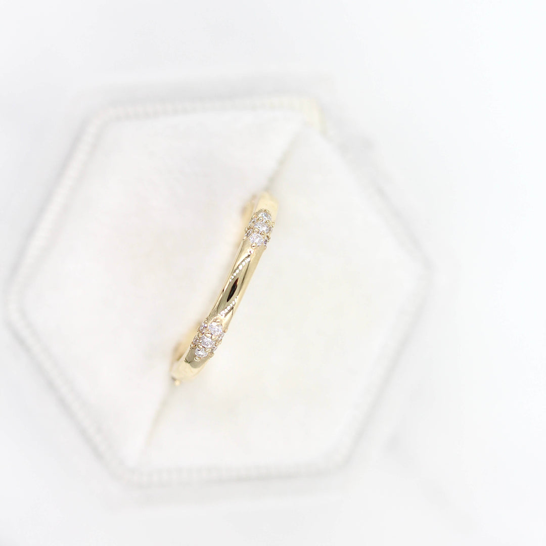 The Chloe Wedding Band in yellow gold in a white velvet ring box