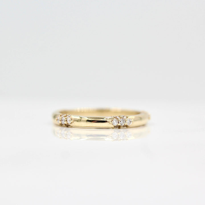  The Chloe Wedding Band in yellow gold against a white background