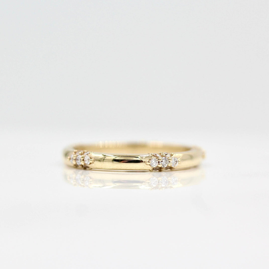  The Chloe Wedding Band in yellow gold against a white background