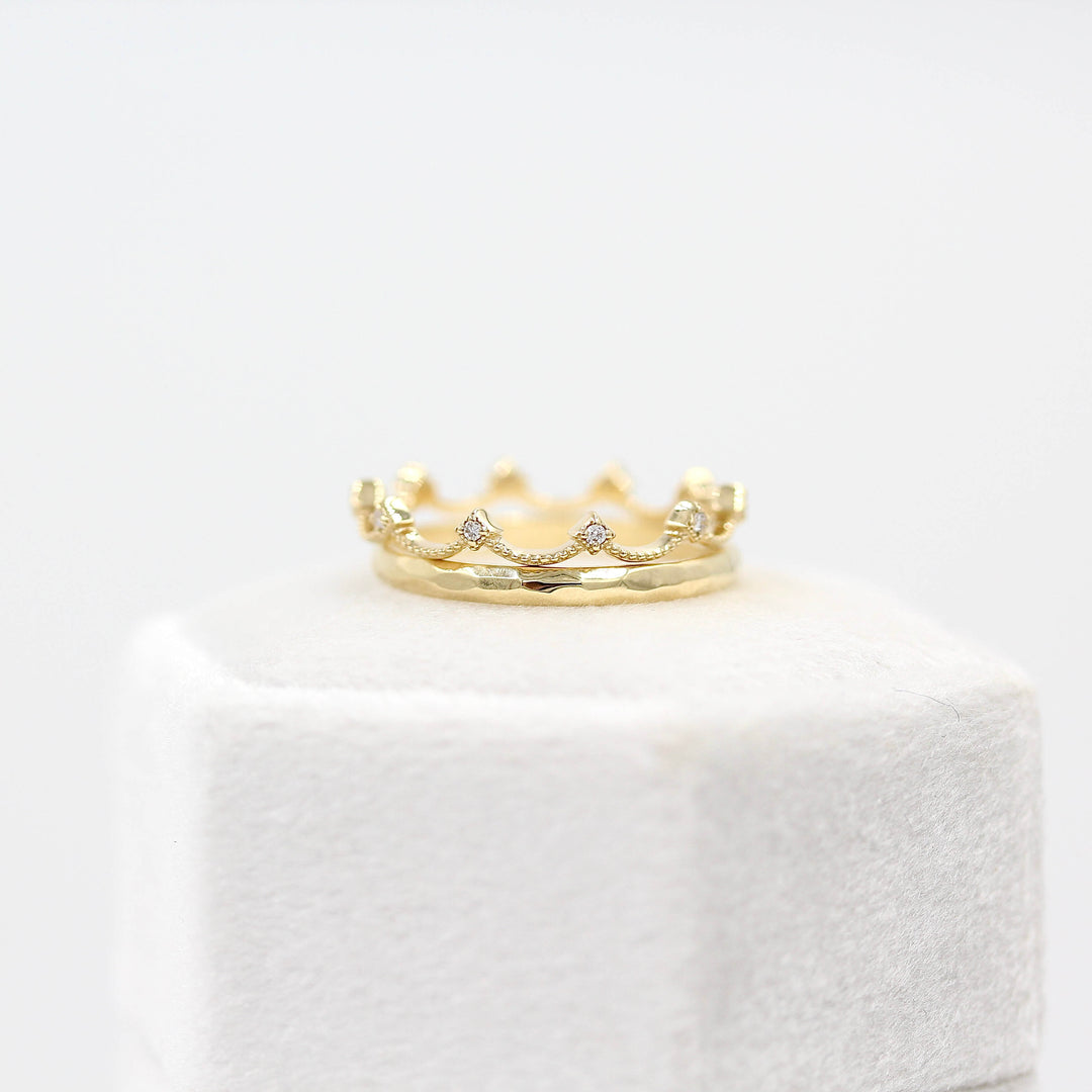 The Christie Bands in Yellow Gold atop a white velvet ring box