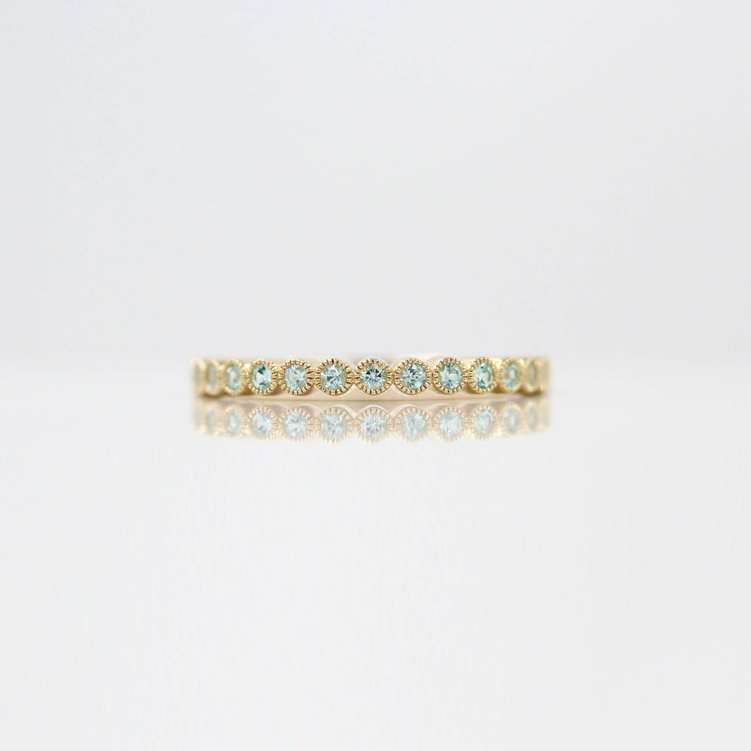 The August Florence Birthstone Wedding Band with Chrysoberyl in Yellow Gold against a white background