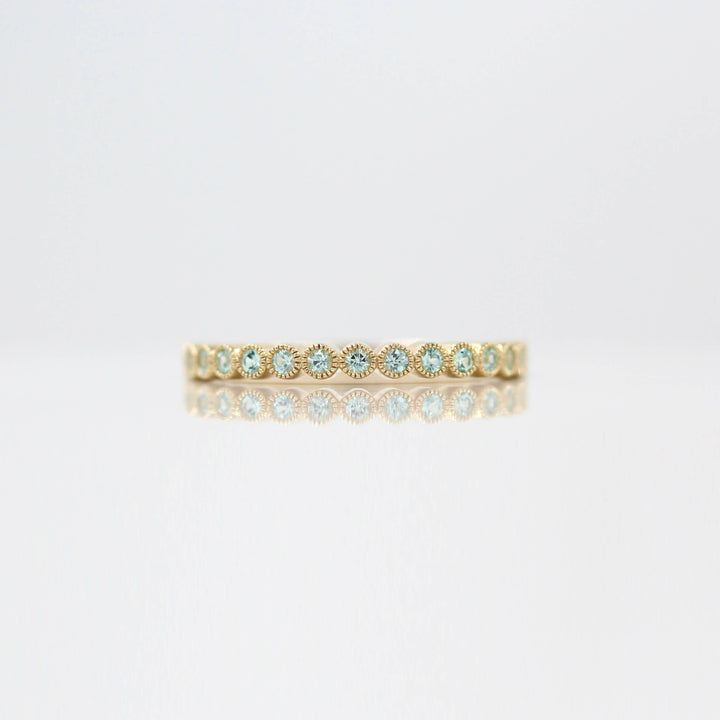 The August Florence Birthstone Wedding Band with Chrysoberyl in Yellow Gold against a white background