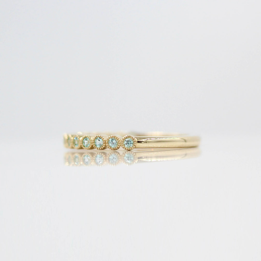 The August Florence Birthstone Wedding Band with Chrysoberyl in Yellow Gold against a white background