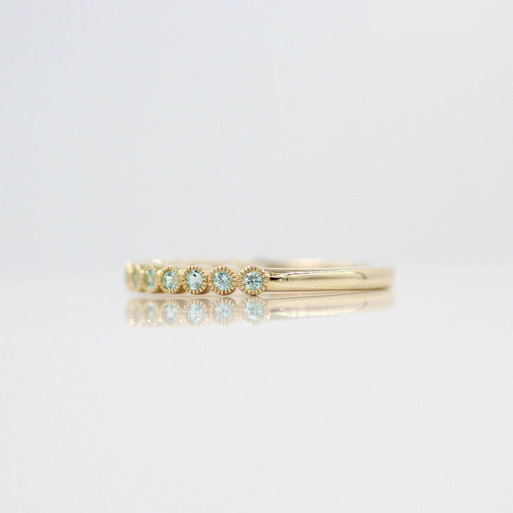The August Florence Birthstone Wedding Band with Chrysoberyl in Yellow Gold against a white background