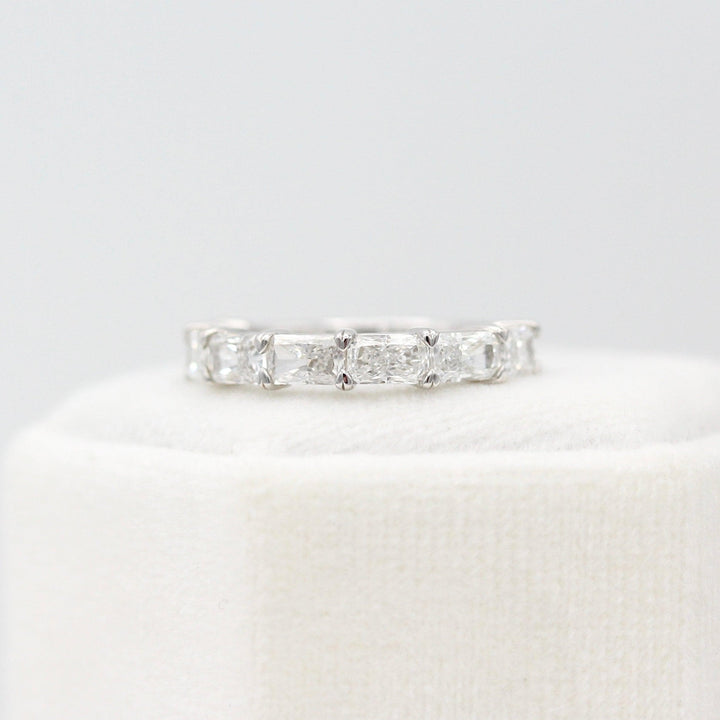 The Clara Wedding Band in White Gold atop of a white velvet ring box
