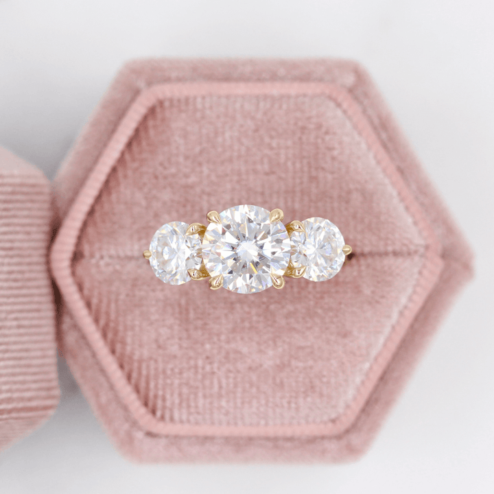 The Corrinne Hidden Halo Ring in Yellow Gold and Moissanite in a pink velvet ring box