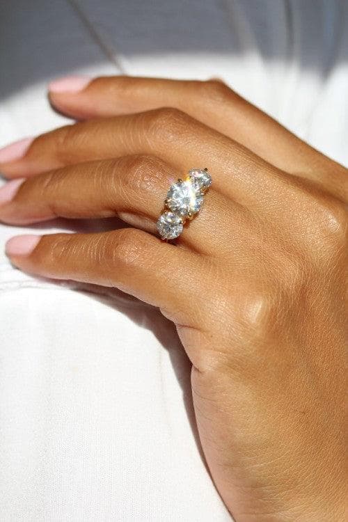 Three-stone diamond engagement ring modeled on a hand