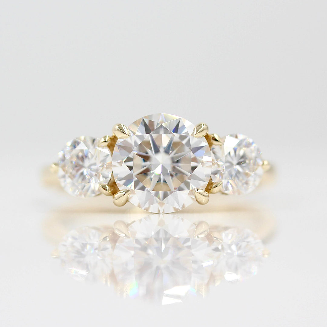 The Corrinne Hidden Halo Ring in Yellow Gold with 2ct Moissanite against a white background