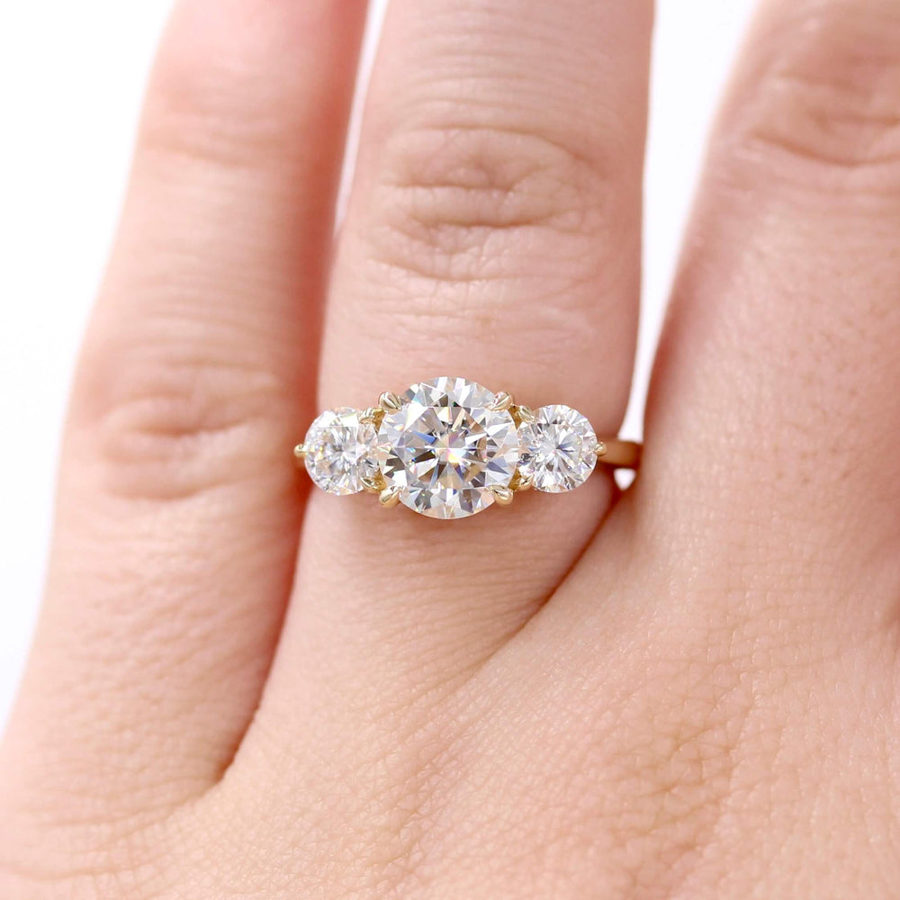 The Corrinne Hidden Halo Ring in Yellow Gold with 2ct Moissanite modeled on a hand