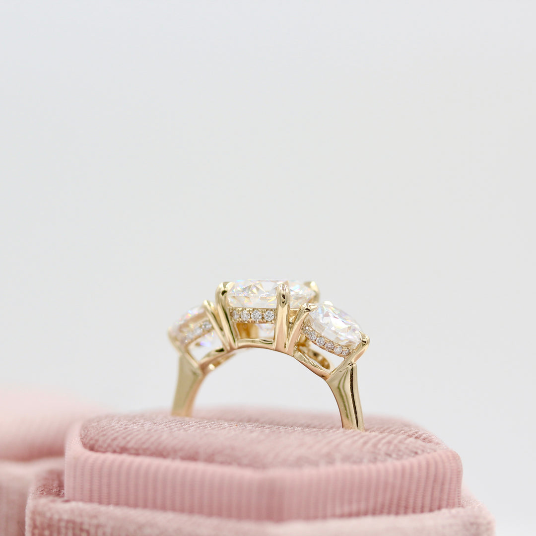 Corrinne Hidden Halo Ring in yellow gold in a pink velvet ring box