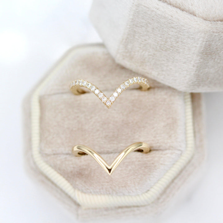The Deep Diamond V Wedding Band in Yellow Gold in a tan velvet ring box with the Deep V Wedding Band in Yellow Gold