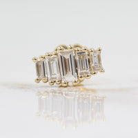 Single diamond baguette five-stone earring against a white background