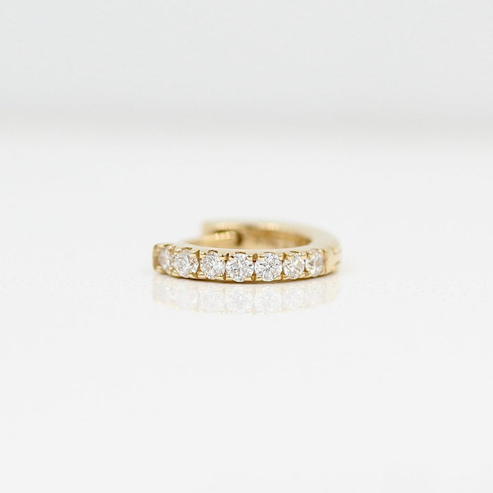 A 10mm single Diamond Huggie in Yellow Gold against a white background